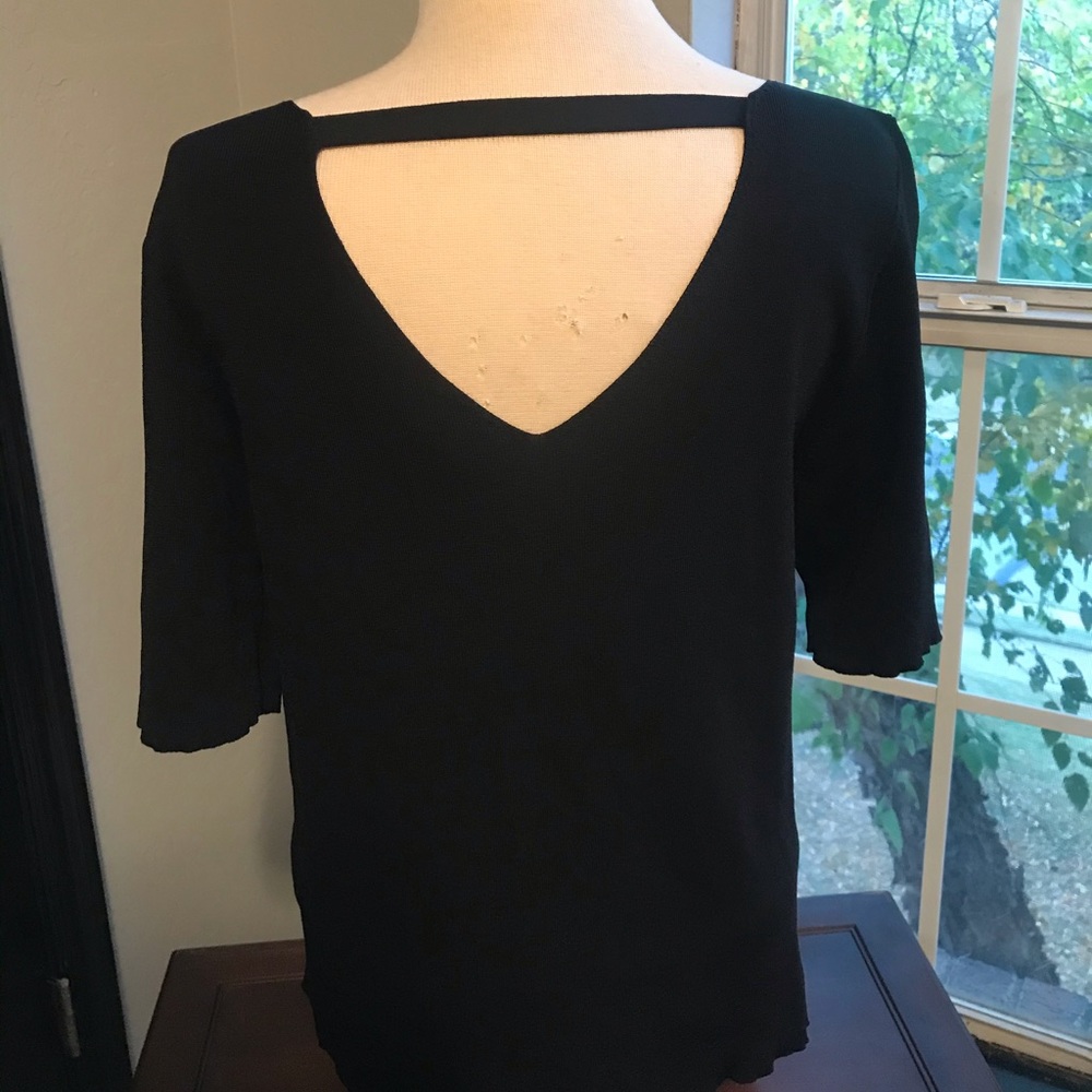 Black top looks great with black pants